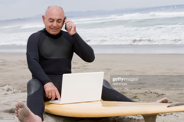 man with a laptop on the beach